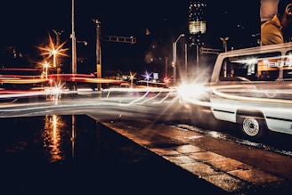 Evening shot of a van with illuminated advertising driving through a busy street.