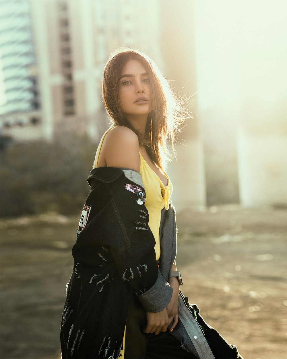 woman taking off her jacket during daytime