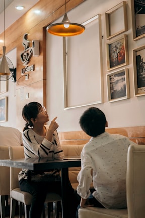 Parents and children enjoying wholesome treats together at the café corner surrounded by playful decor.