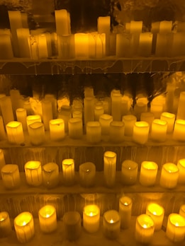 A selection of beeswax candles in warm, natural tones.