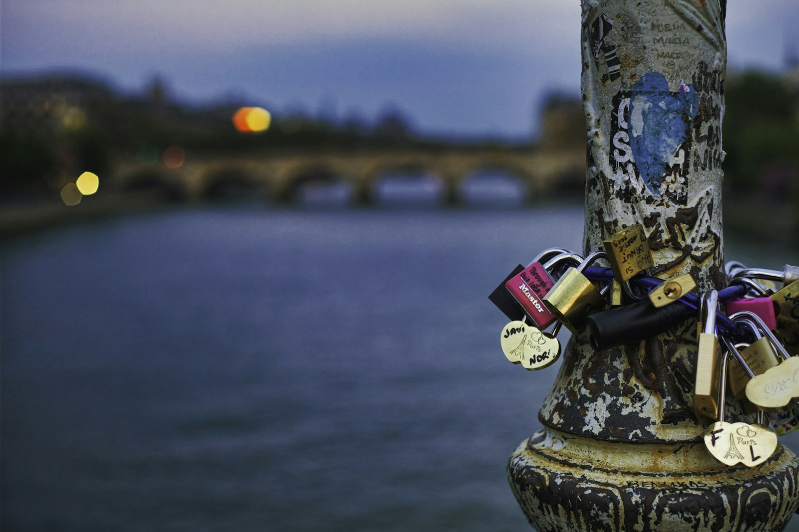 Love padlocks attached to the railing of the Pont des Arts in Paris