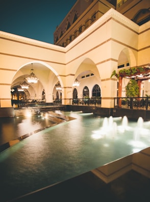 Elegant riad courtyard adorned with traditional Moroccan lanterns and lush greenery.