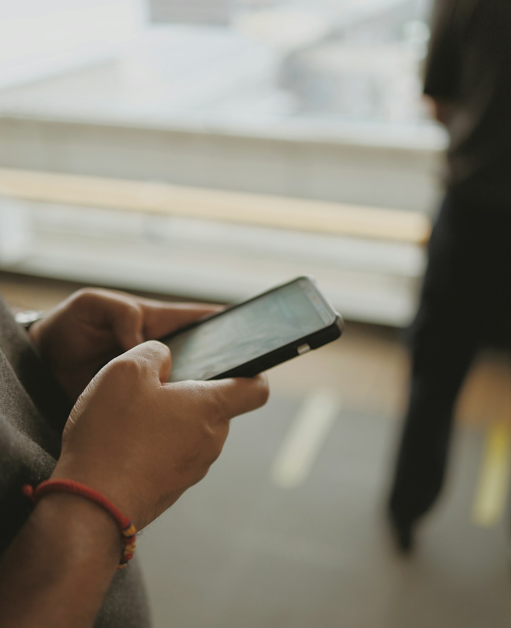 selective focus photography of person using phone