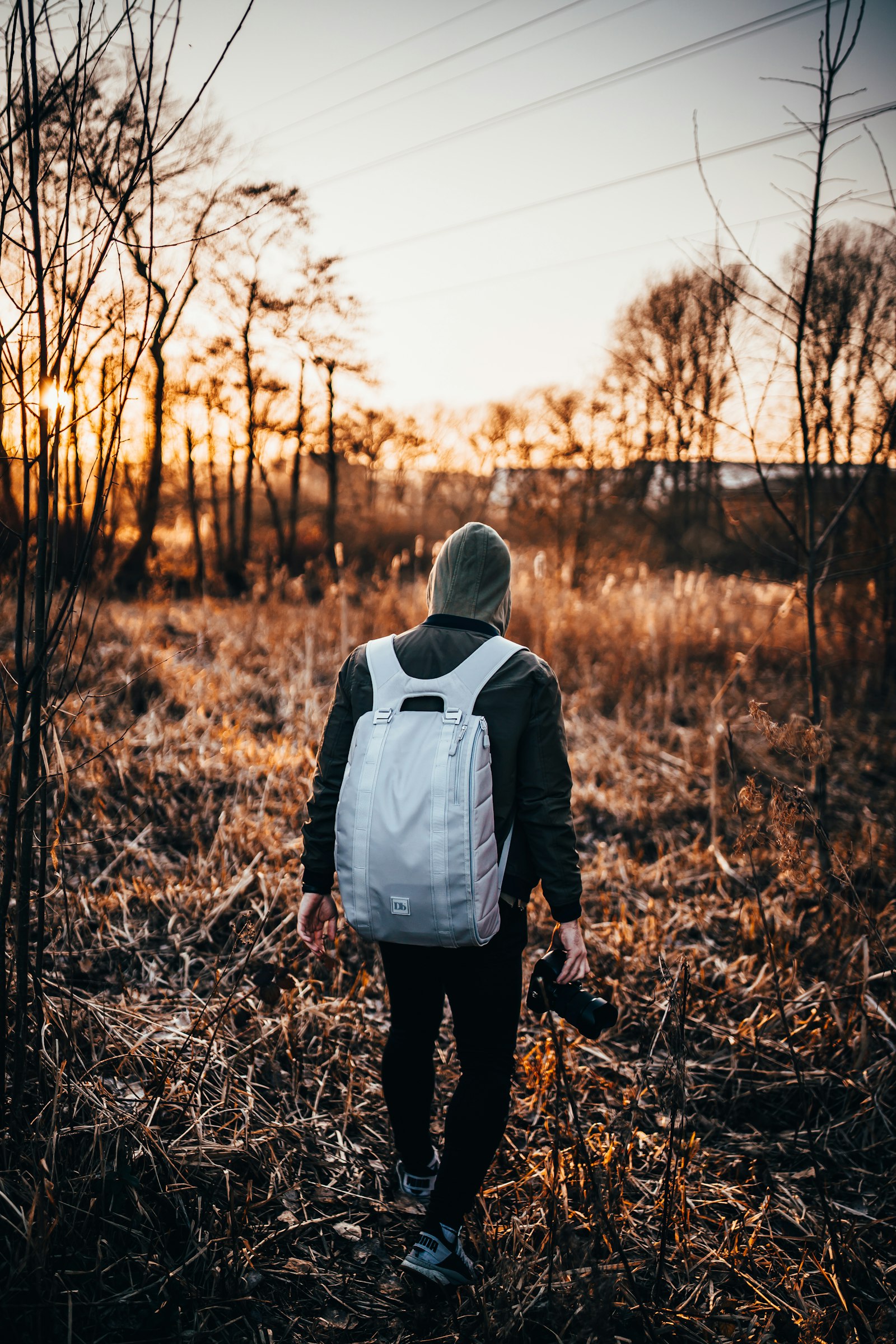 Sony a7 III + Samyang AF 35mm F1.4 FE sample photo. Person walking on grass photography