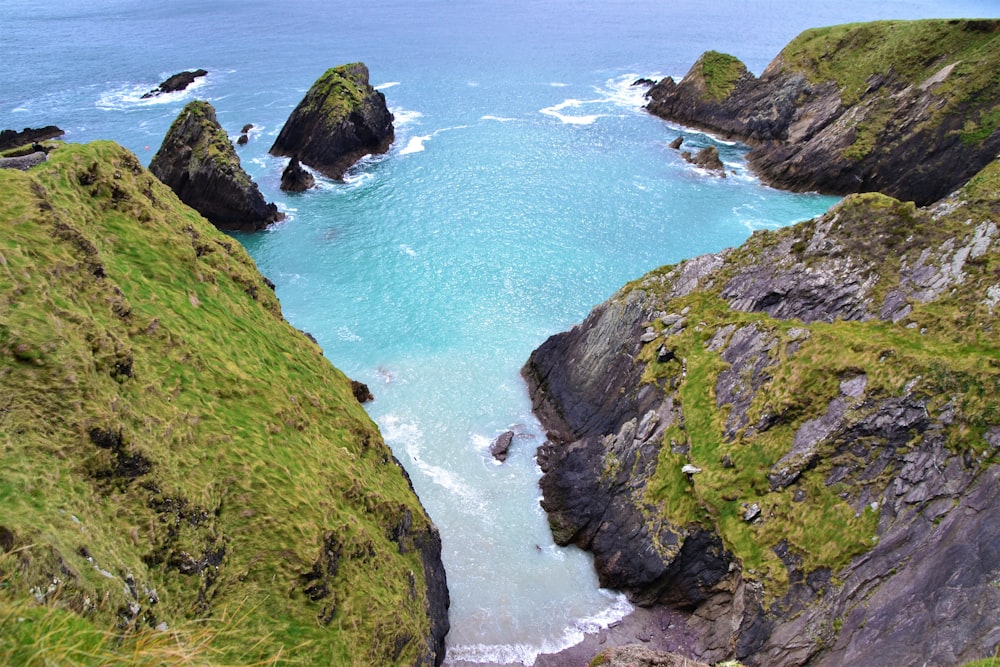 cove beach surrounded with rock walls