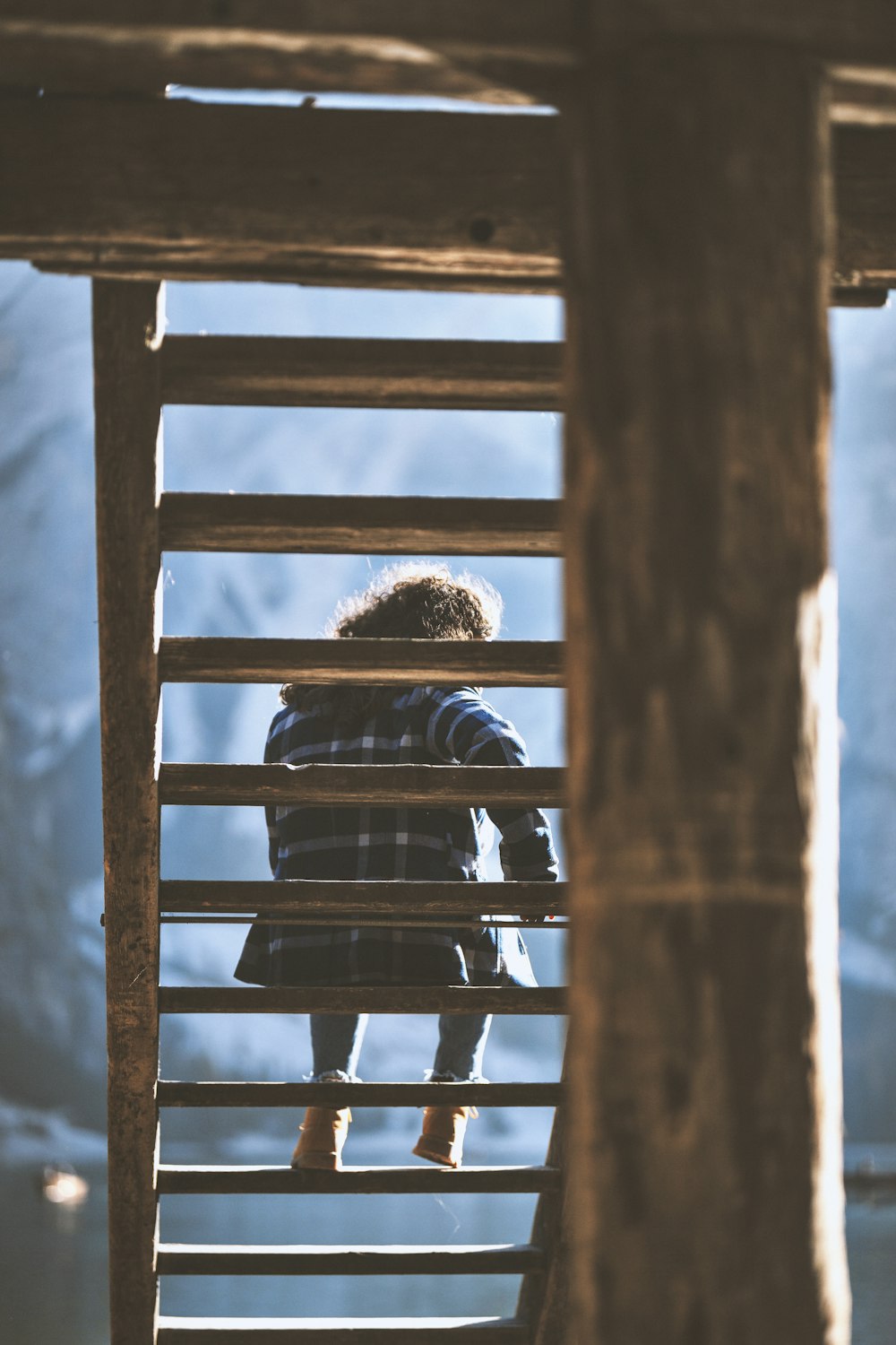 girl sitting on ladder