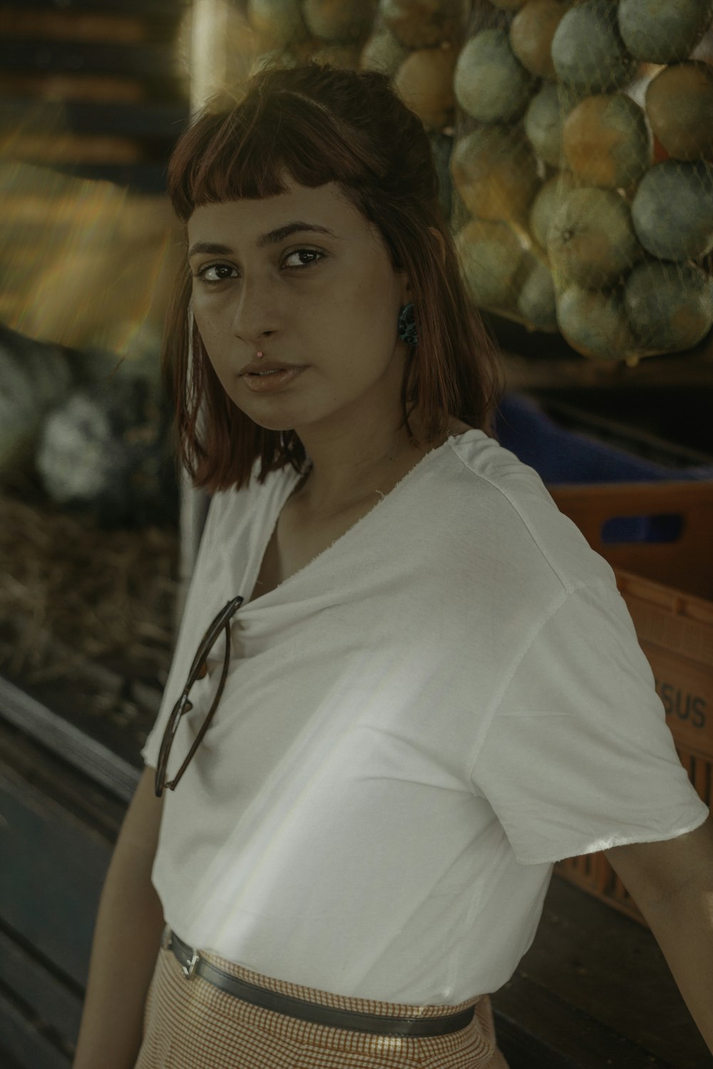 woman in white blouse standing near plastic crate