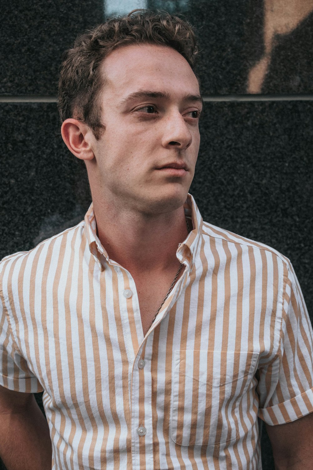 man wearing brown striped shirt