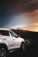 A comfortable SUV parked in front of a historic Rajasthan palace, ready for a sightseeing tour