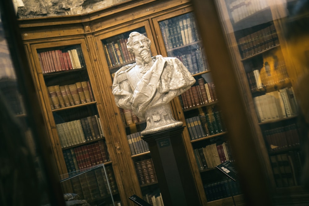 soldier man statue near different books in shelf