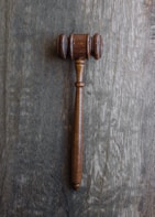 Close-up of legal books and documents on a wooden desk with a gavel