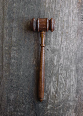 A close-up of legal books and a gavel on a wooden desk, symbolizing justice and law.