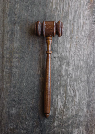 A tasteful arrangement of legal scales and a gavel resting on a charcoal gray desk, symbolizing justice.
