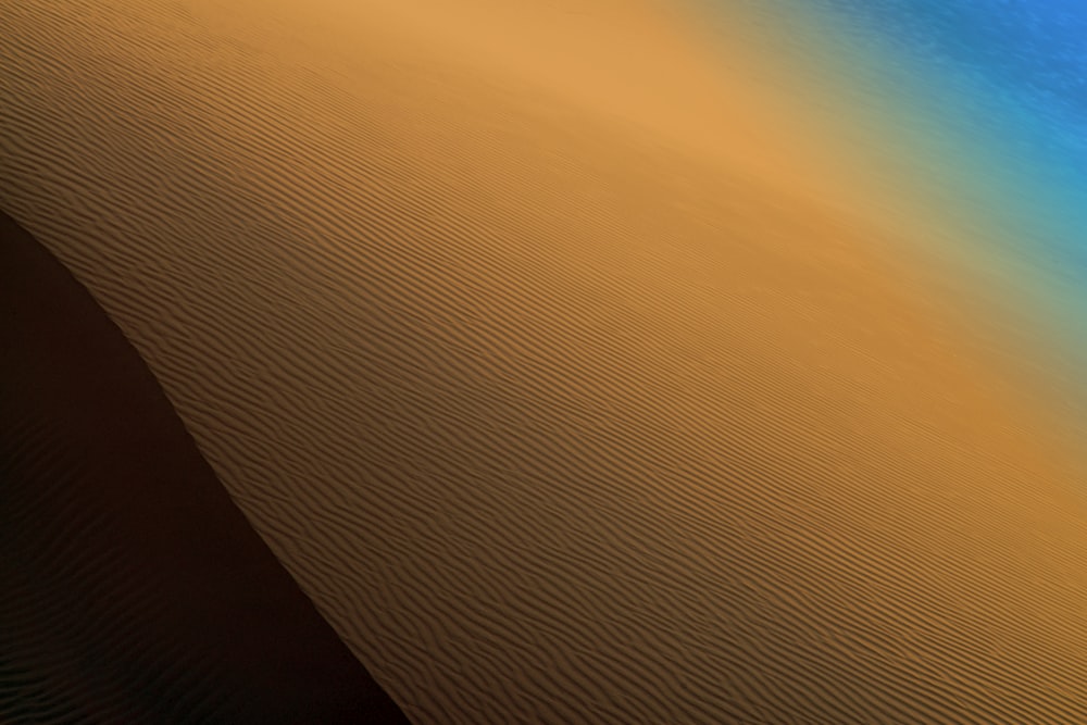 a desert landscape with sand dunes and blue sky