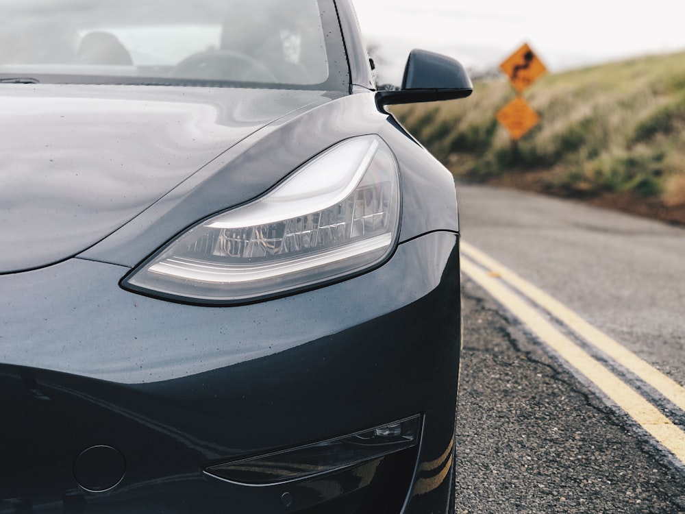 black vehicle parked on road