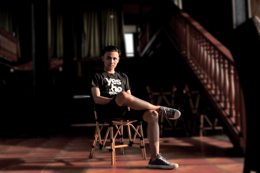 man sitting on chair in room