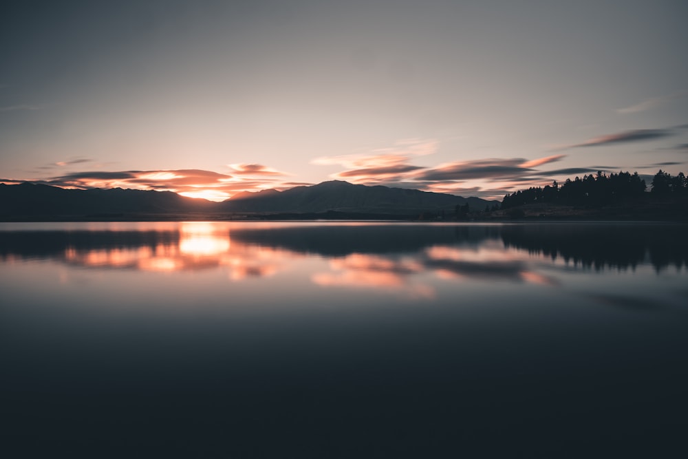 body of water with mountain background