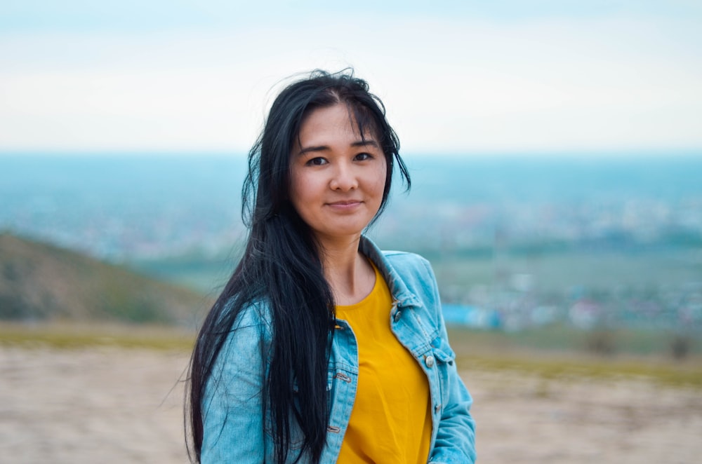 woman wearing blue denim jacket with yellow shirt