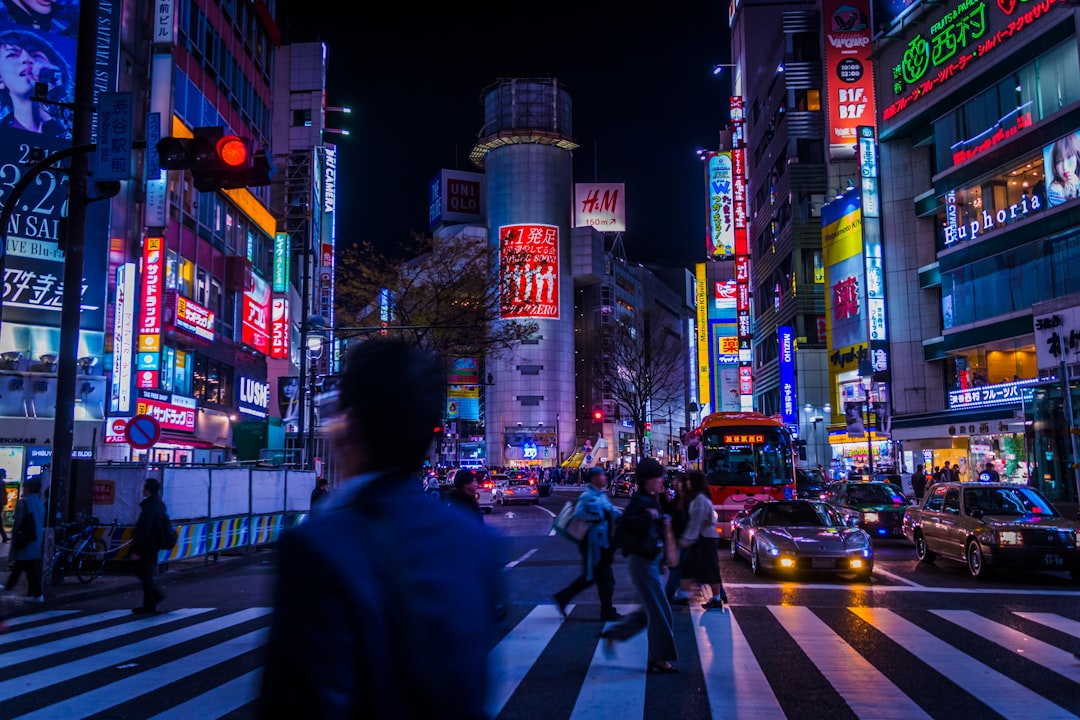 person crossing on pedestrian lane, Shibuya 109 lost logo in April 2019. Tokyo Night Photography.</p></figure><p>I