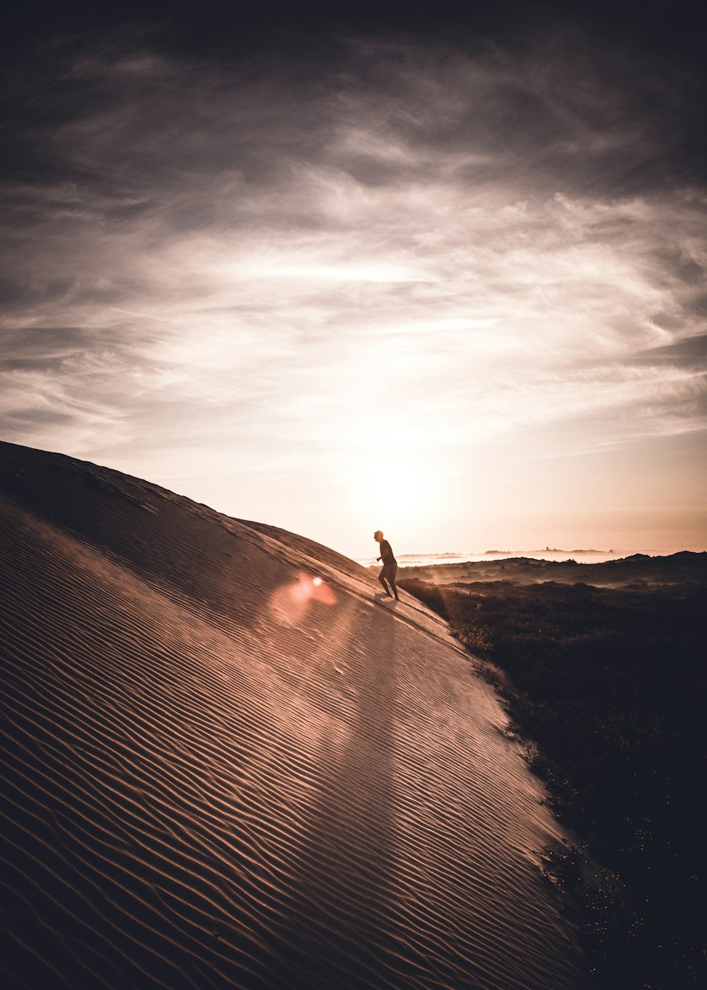 man walking up on sand