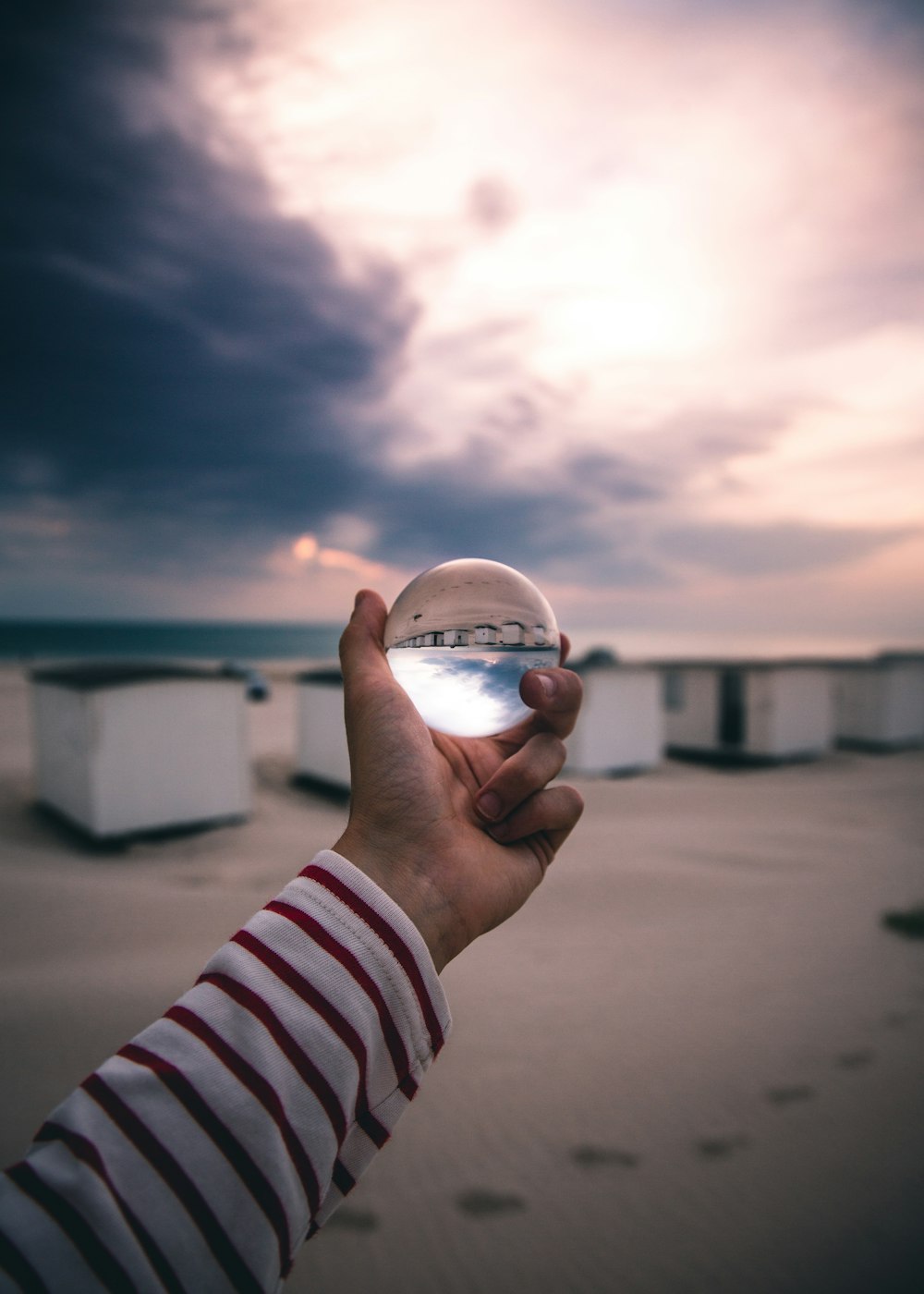 person holding glass ball