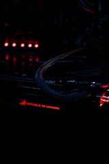 Close-up of a high-end gaming PC motherboard with glowing RGB lights in a dark room