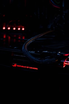 Close-up of a high-end gaming PC motherboard with glowing RGB lights in a dark room