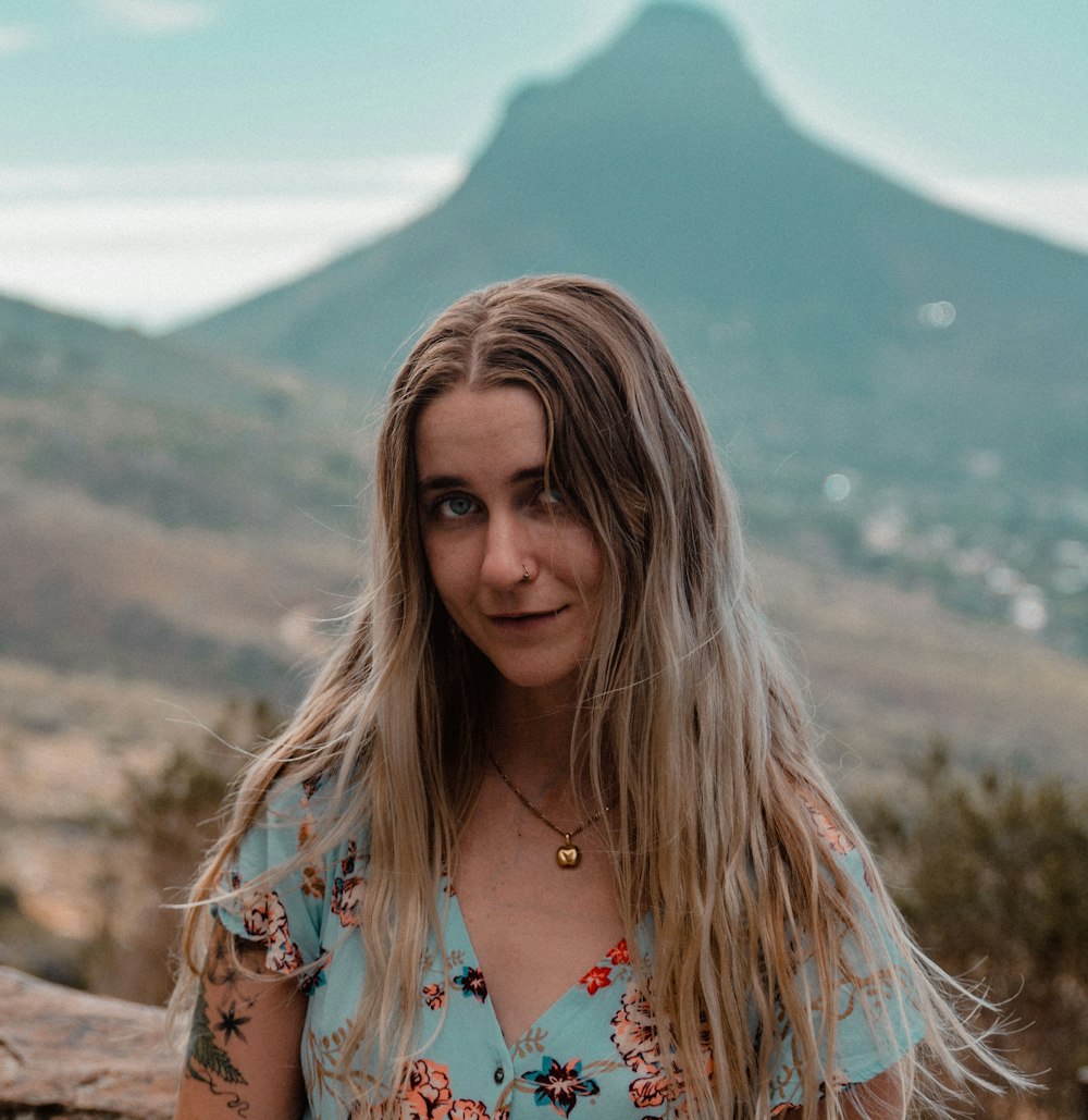 woman wearing blue and pink floral top