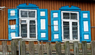 Sparkling clean windows and wooden shutters of a rustic house in Allauch