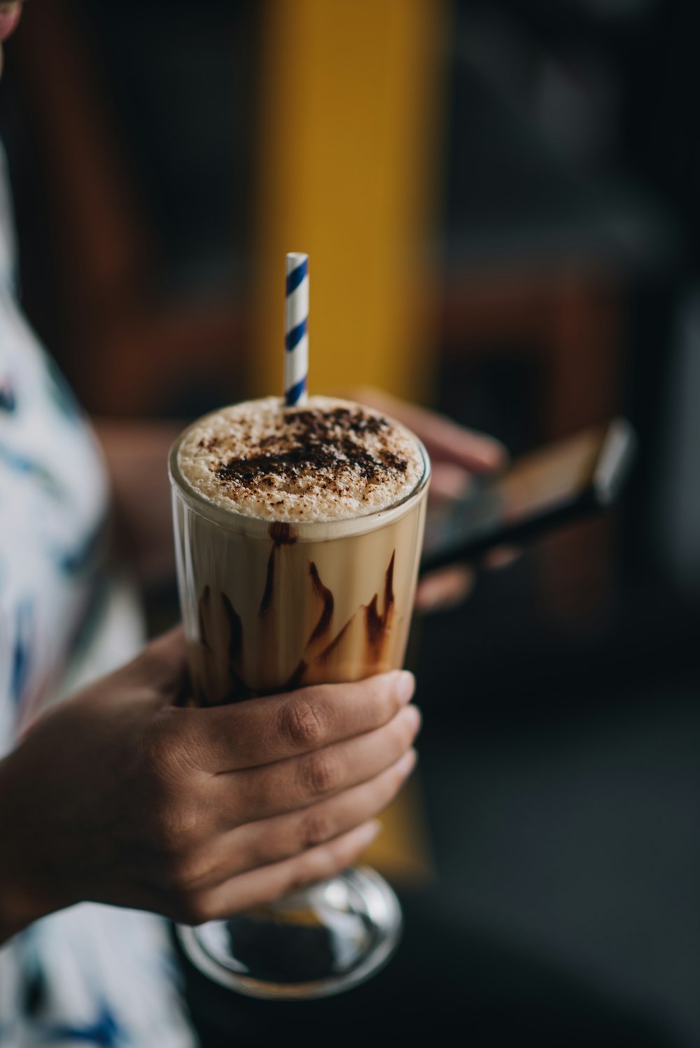 person holding chocolate shake