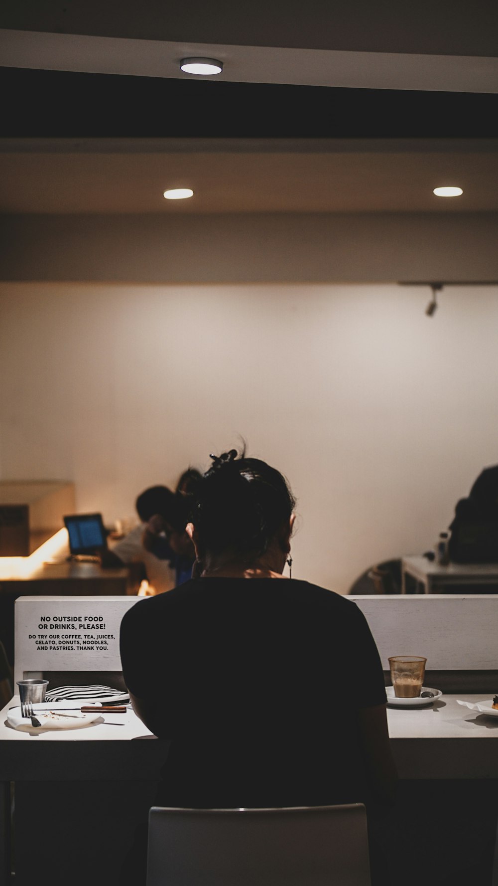 woman sitting in front of table