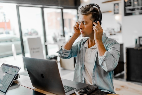 A candid shot of a team member working at their desk, headphones on, immersed in their creative process.