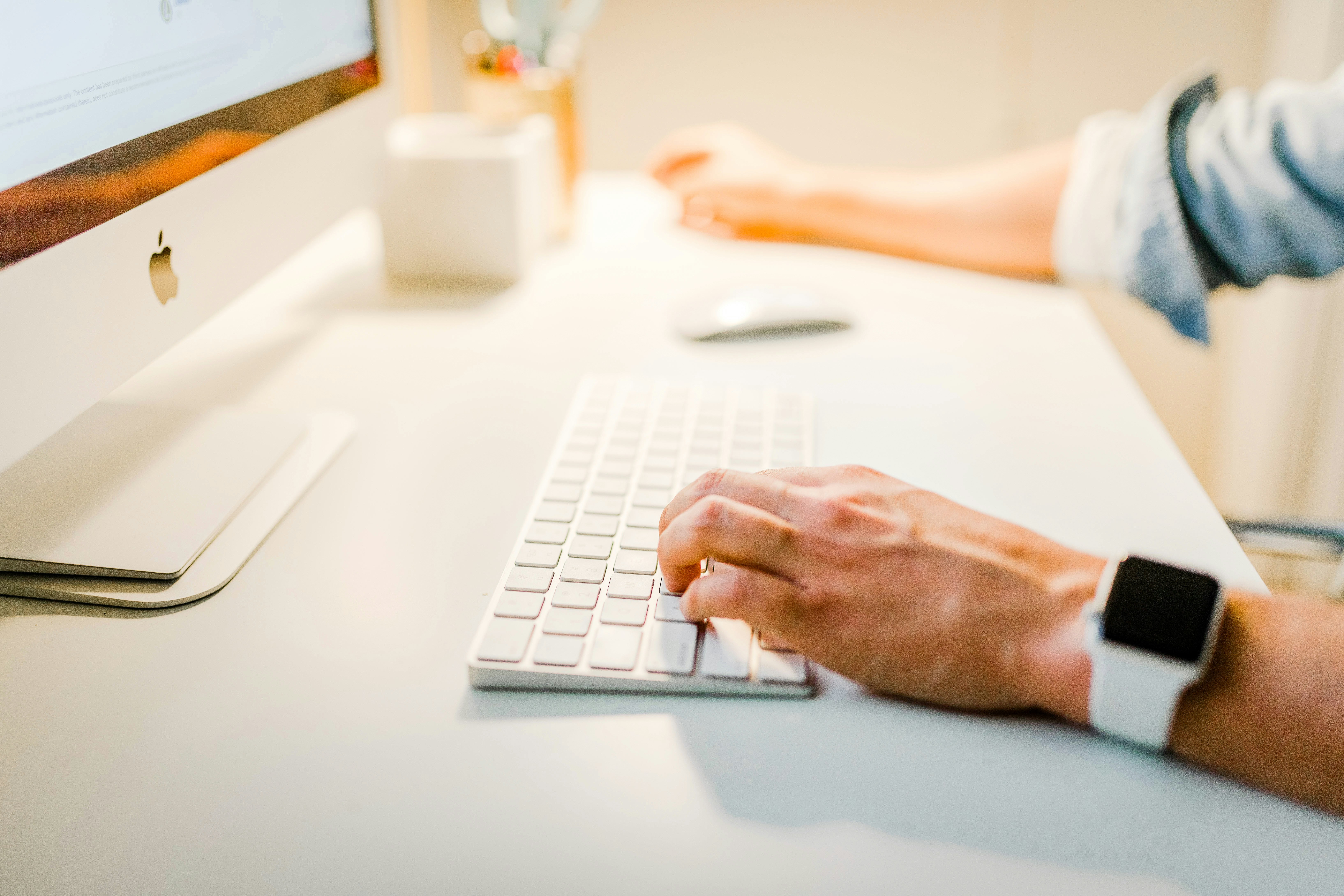 person using iMac and writing content