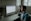 A person sitting at a desk, reviewing financial documents with a laptop open, symbolizing financial planning.