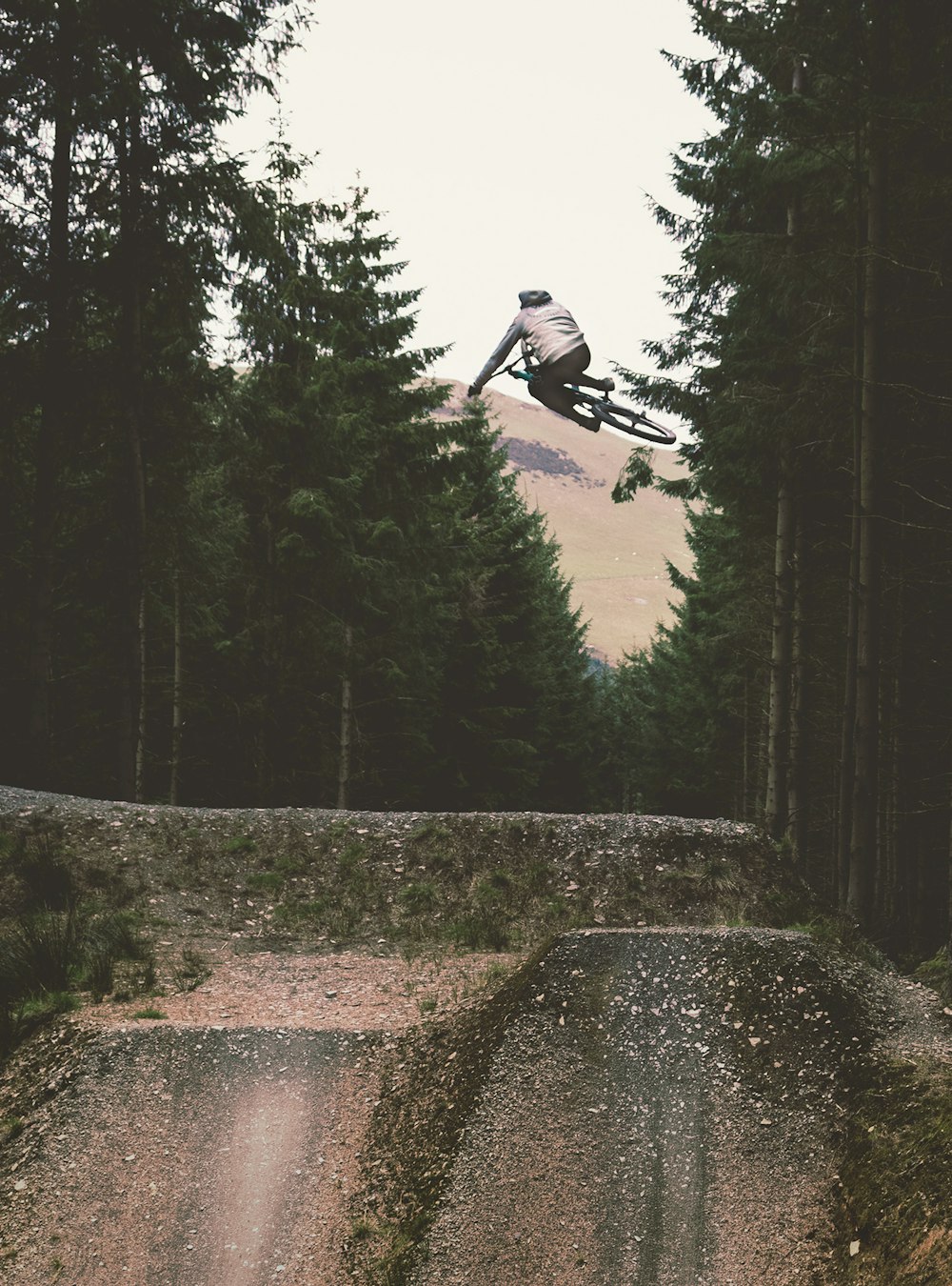 time lapse photography of man doing bicycle tricks on air