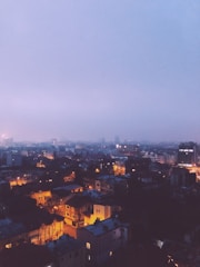 A tasteful, softly lit image of a welcoming cityscape of Noida at dusk.