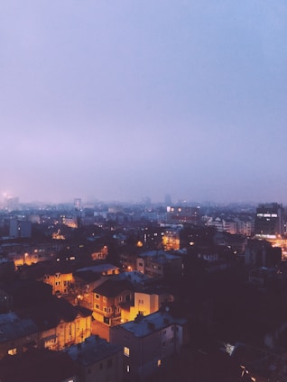 A tasteful, softly lit image of a welcoming cityscape of Noida at dusk.