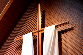 brown wooden cross against wall