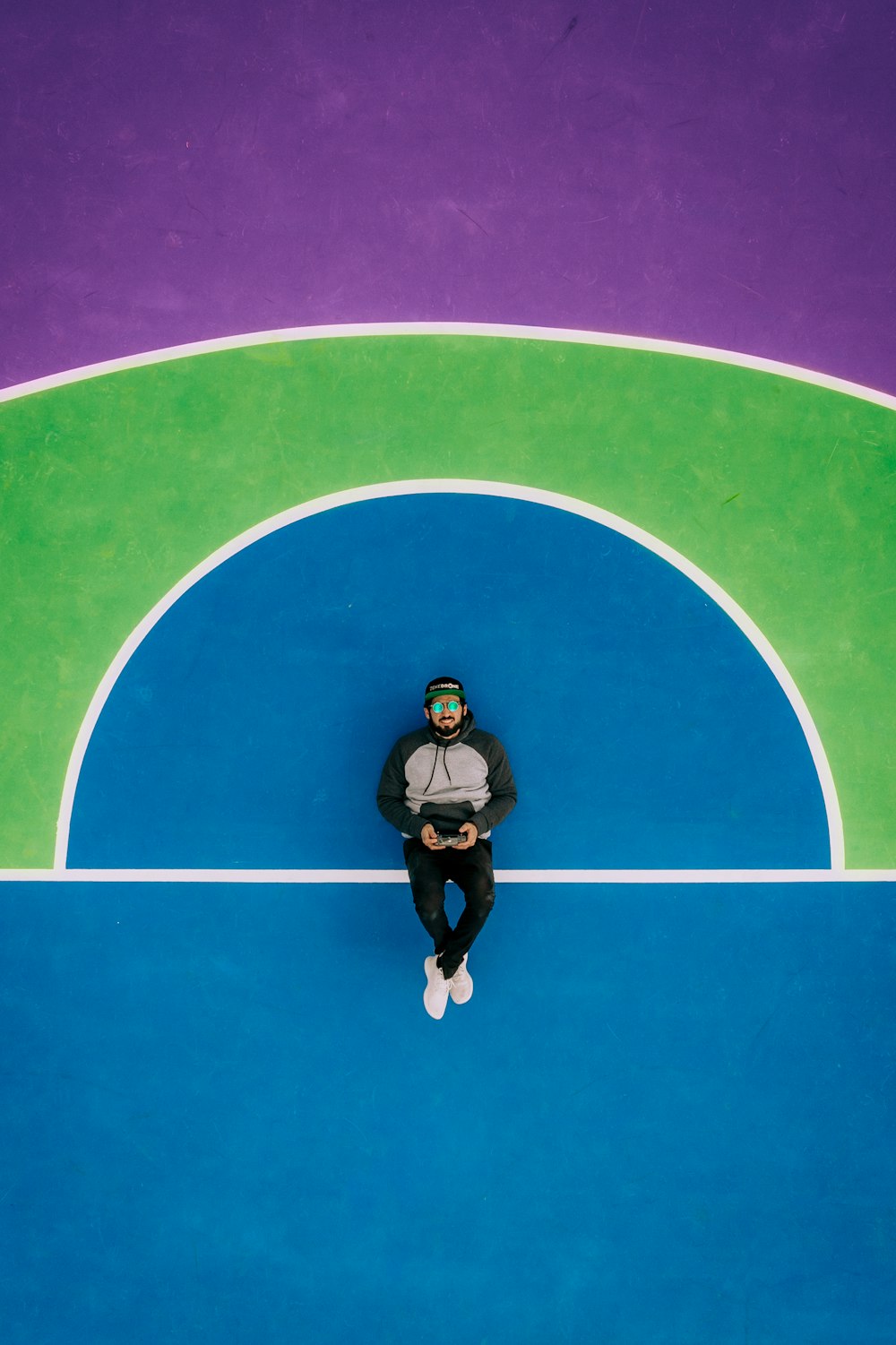 man leaning on blue wall