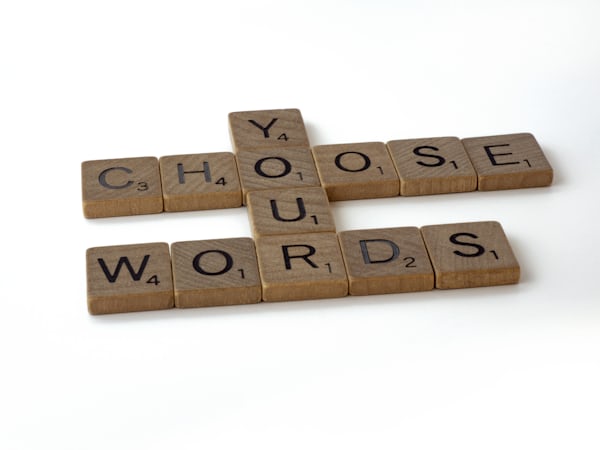 picture of scrabble tiles spelling out choose your words