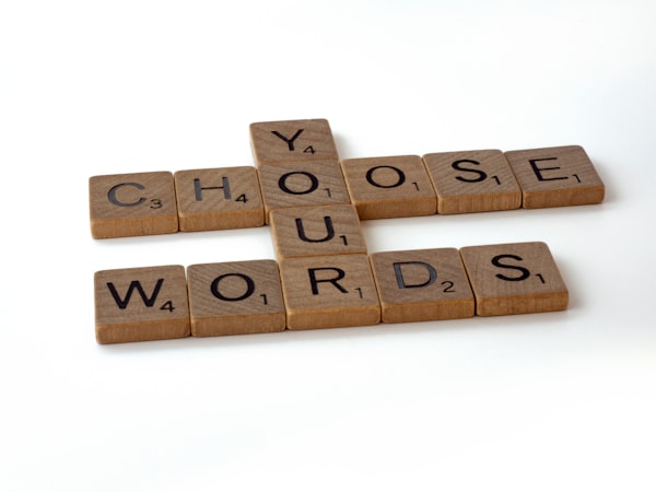 Scrabble letters displaying the text: "Choose Your Words"