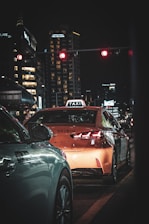 A modern taxi car waiting at a city street in Kuwait during the day.