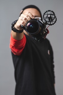 person holding black camera