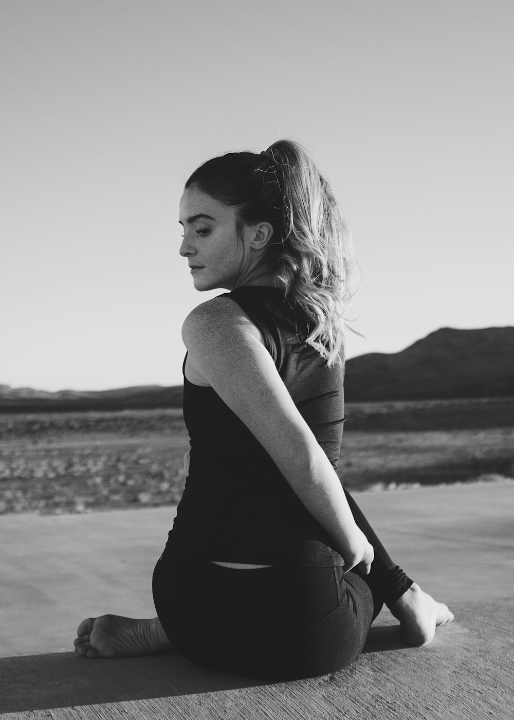 woman in black tank top sitting