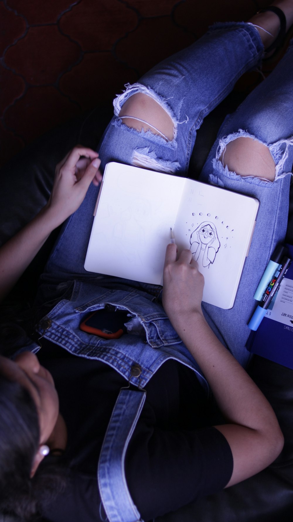 woman sitting while sketching