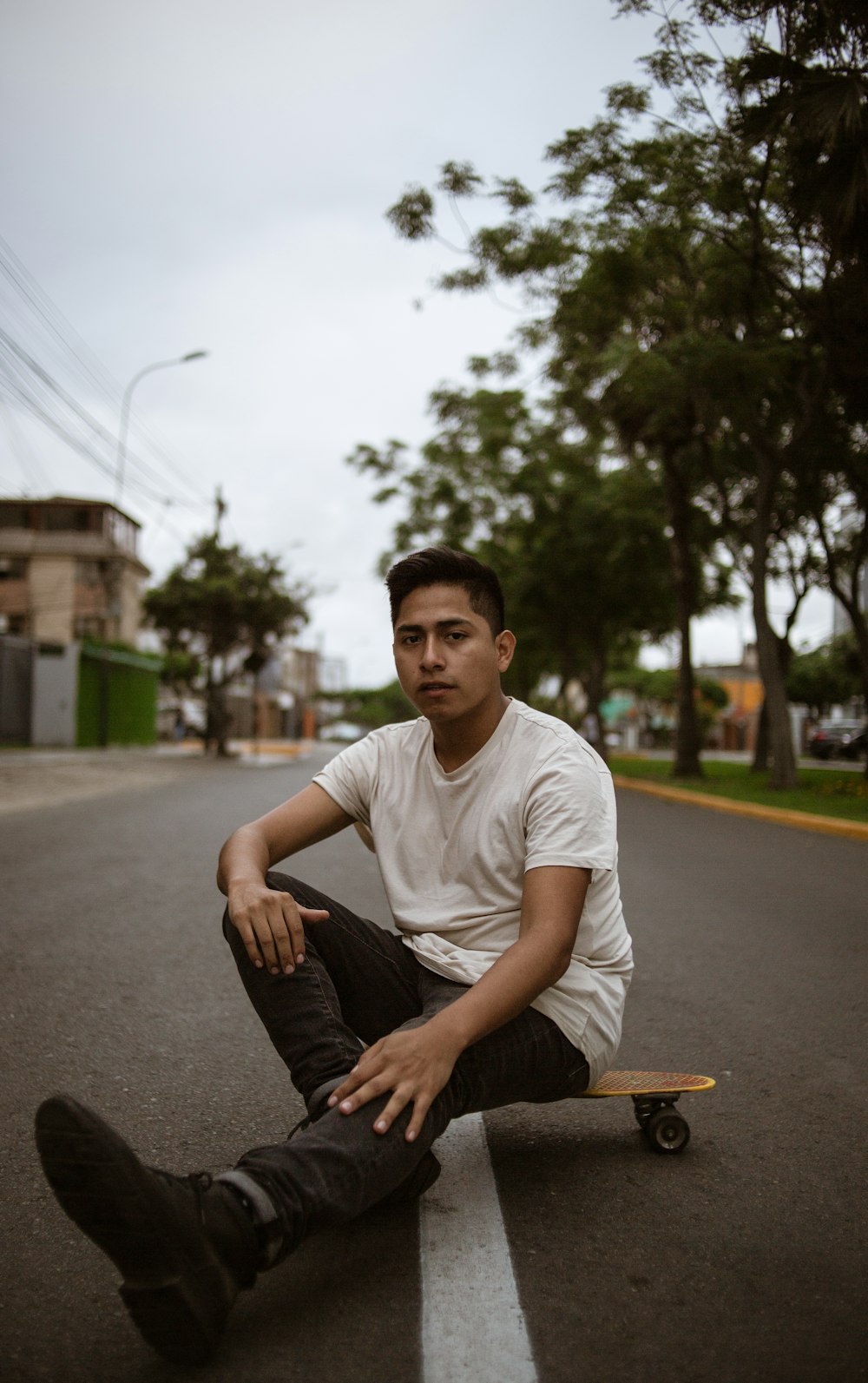 man sitting on skateboard