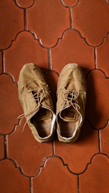 Casual women's shoes with warm tones placed near a sunny window.