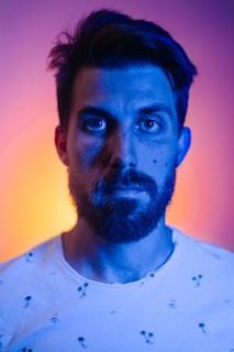 A professional headshot of Abdullah Jakhar with a dark background and neon blue lighting accents.