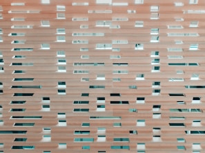 Room partition made of natural wood slats blending privacy and openness