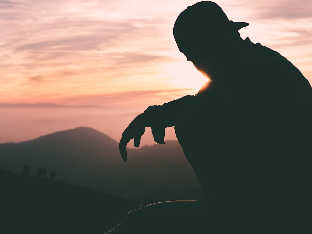 silhouette of person wearing cap